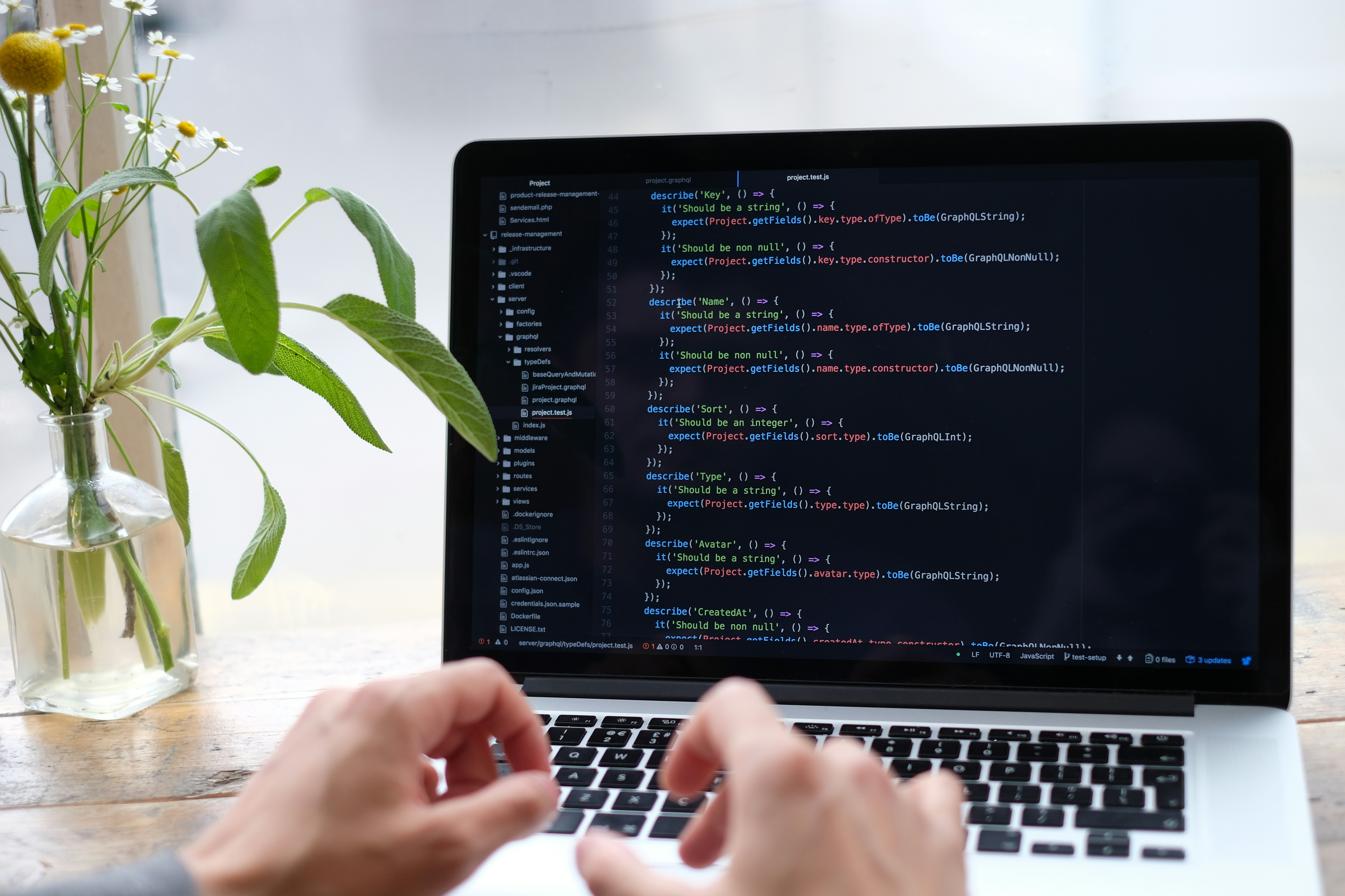 Developer working at a laptop in a bright workspace